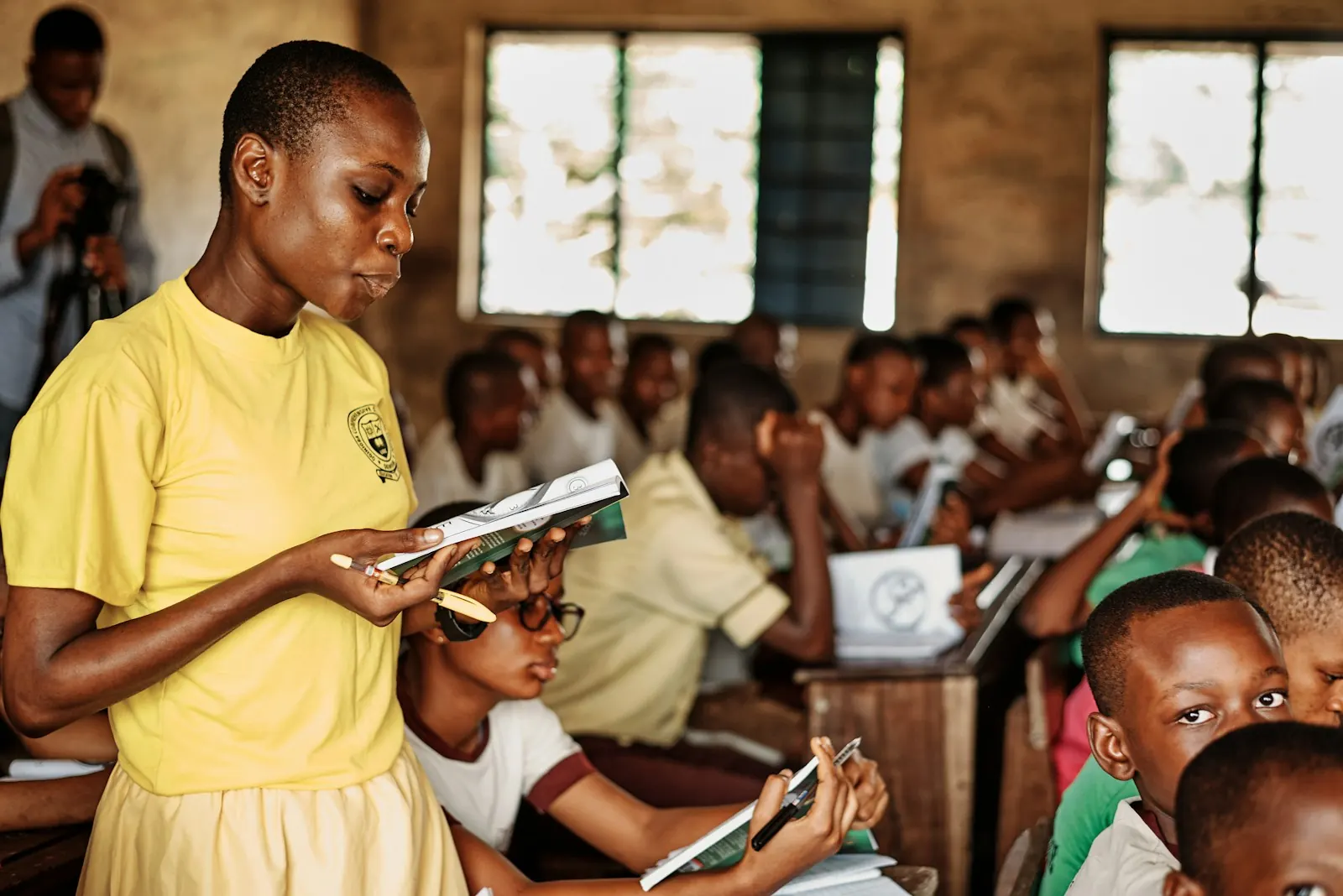 A teacher standing in front of a class of children
