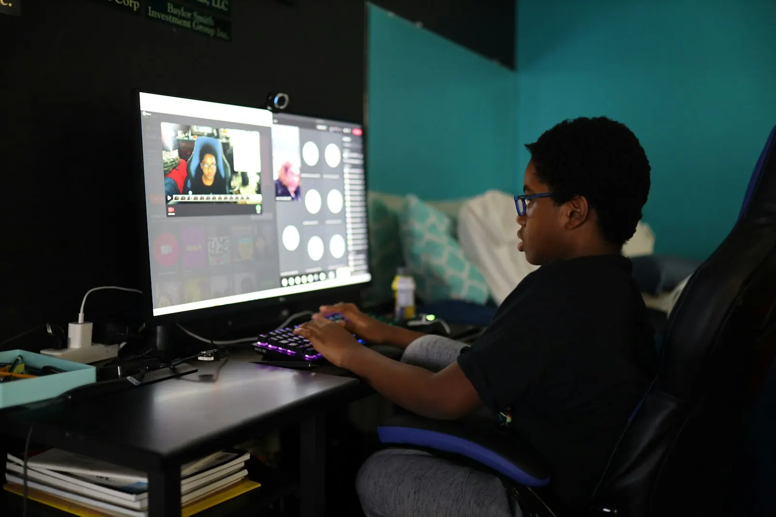 A creator at his desk setting up a stream on a large monitor